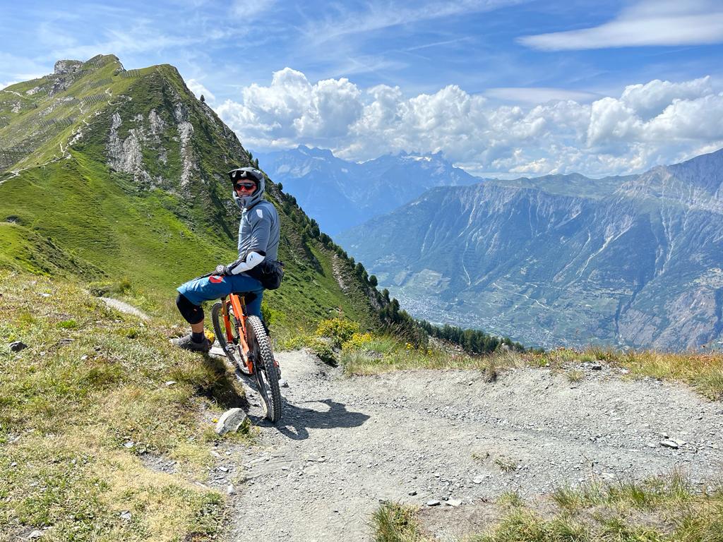 Placeholder: mountain bike rider on an alpine trail