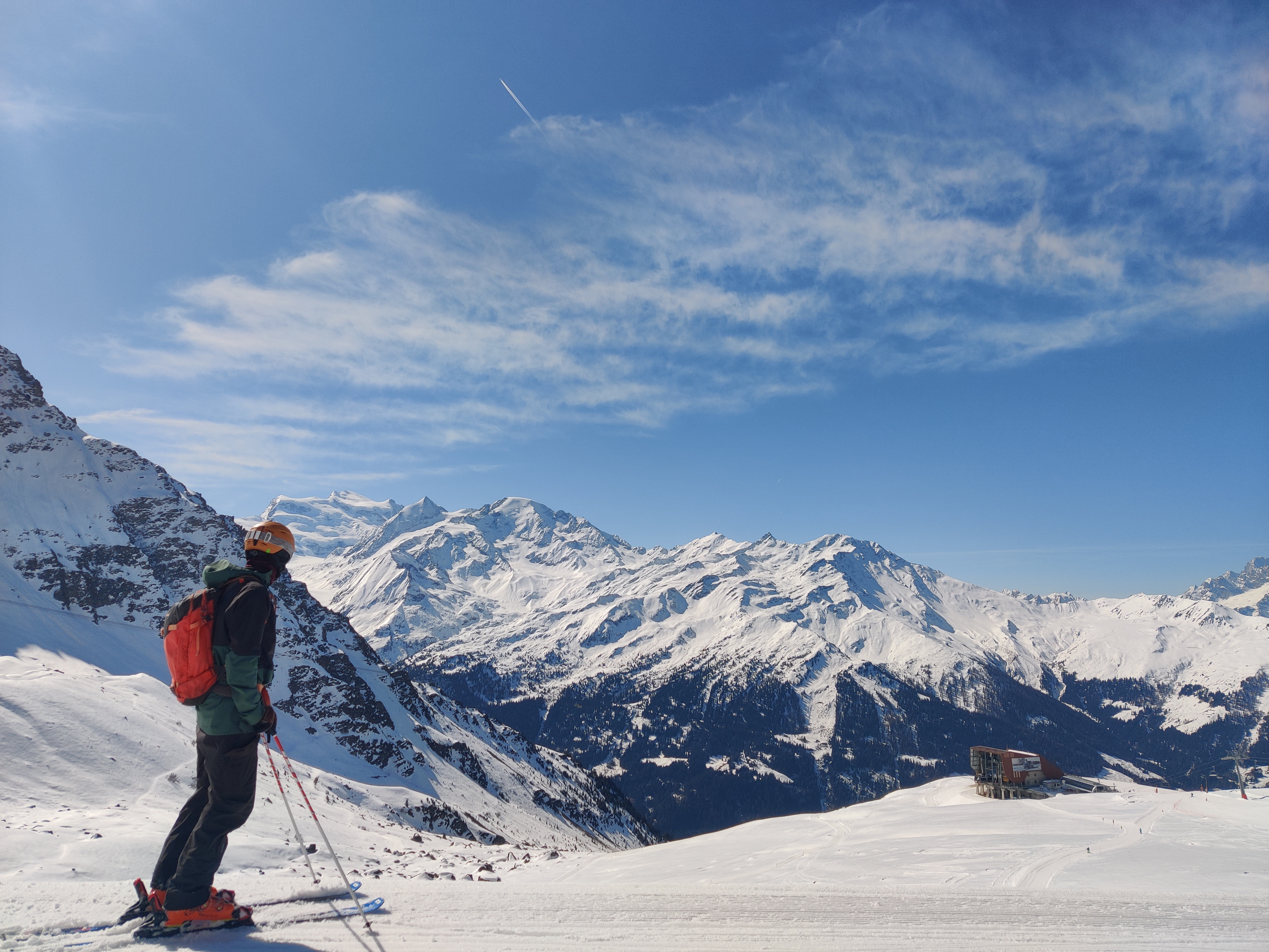 Skier moving through a snowy Alpine landscape